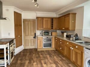 Fully equipped kitchen with oven, hob, fridge and food preparation space at Tre, Westminster Residence