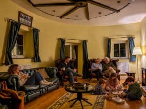 Multi generational family relaxing together in the Witches Mill lounge