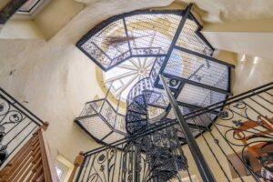 The spiral staircase and gallery at the Witches Mill Spiral staircase leading to the elevated steel-mesh gallery inside the Witches Mill, part of your unique holiday cottages experience